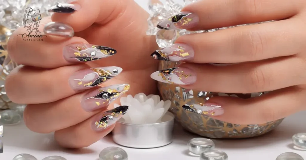 Elegant acrylic nails decorated with black, gold flakes, and gems showcasing acrylic gem durability and long-lasting shine.